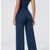 A woman wearing a navy blue high-waist yoga and gym leggings set from the back view.
