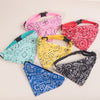 A collection of colorful, patterned adjustable pet scarves for dogs and kittens.