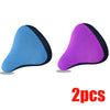 A pair of purple and blue breathable 3D mesh bicycle saddle cushions.