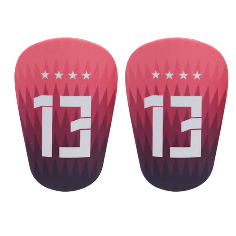 A pair of pink mini football shin guards for youth and adult players.