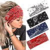 A woman wearing a bohemian print wide headband for yoga or running.