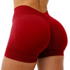 A close-up of a woman wearing seamless red yoga shorts for fitness and workout.