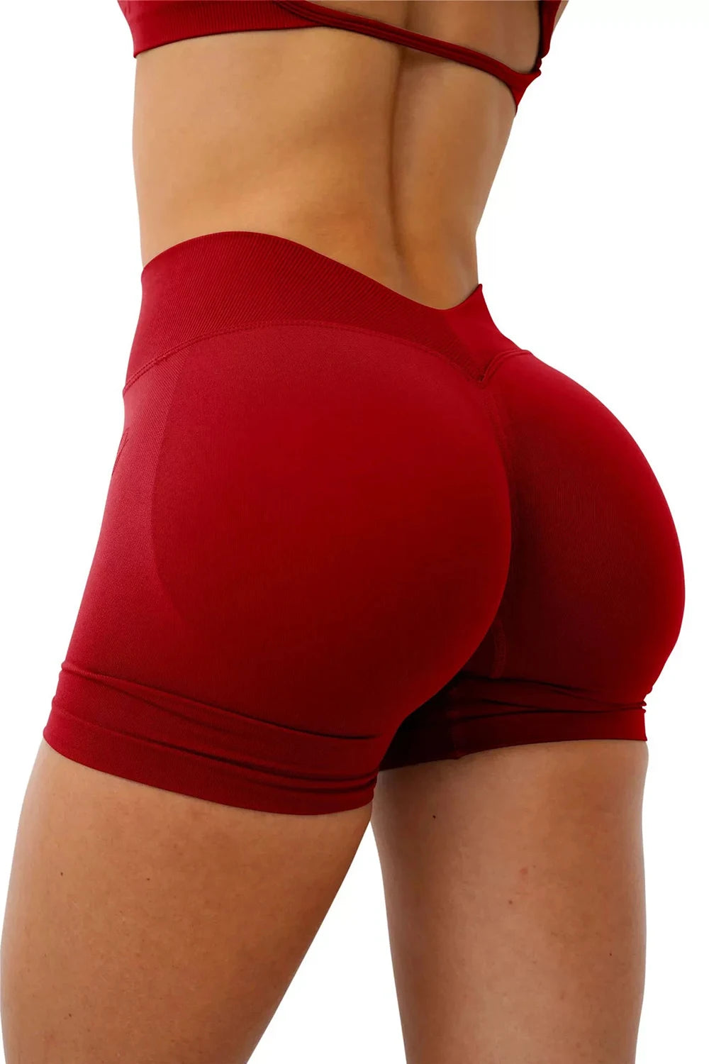 A close-up of a woman wearing seamless red yoga shorts for fitness and workout.