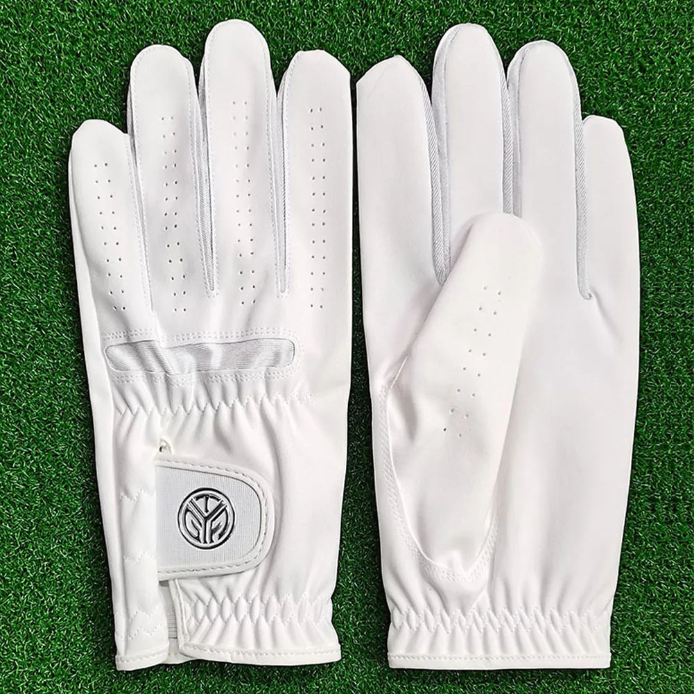 A pair of white men's breathable golf gloves lying on green grass.