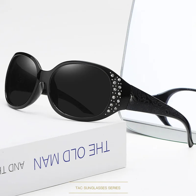 Black diamond-inlaid polarized sunglasses displayed on a white box.