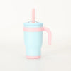 A light blue stainless steel travel mug with a pink lid and handle.