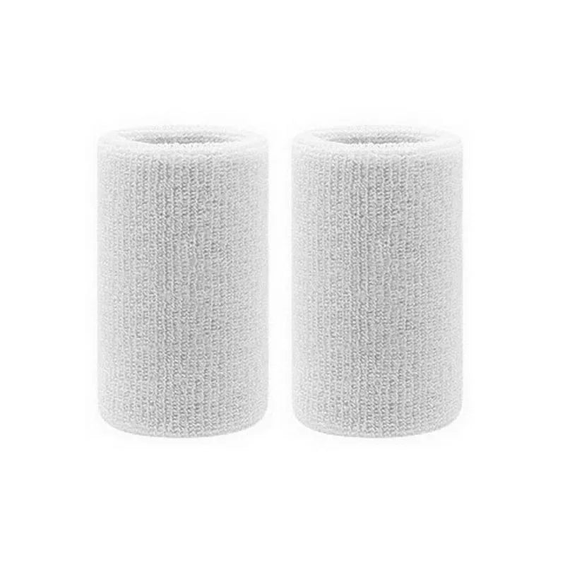 A pair of white dual sports wristbands for sweat absorption, cylindrical in shape.