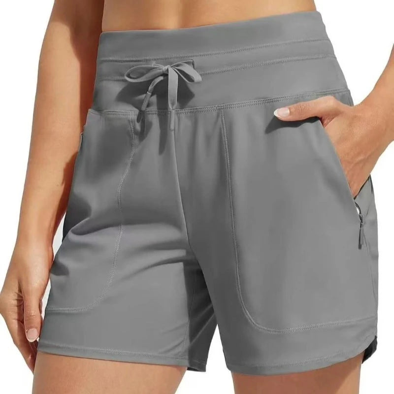 Gray high-waisted quick-dry athletic shorts worn by a person.