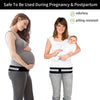A woman wearing a black pelvic support hip belt for lower back and SI joint relief while holding a baby.