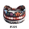 A close-up of a patterned boho cotton turban headband with floral and geometric designs.