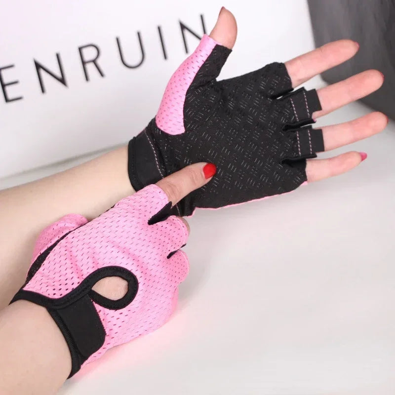 A hand wearing a pink fingerless gym glove and a black fingerless glove, displayed against a white background.