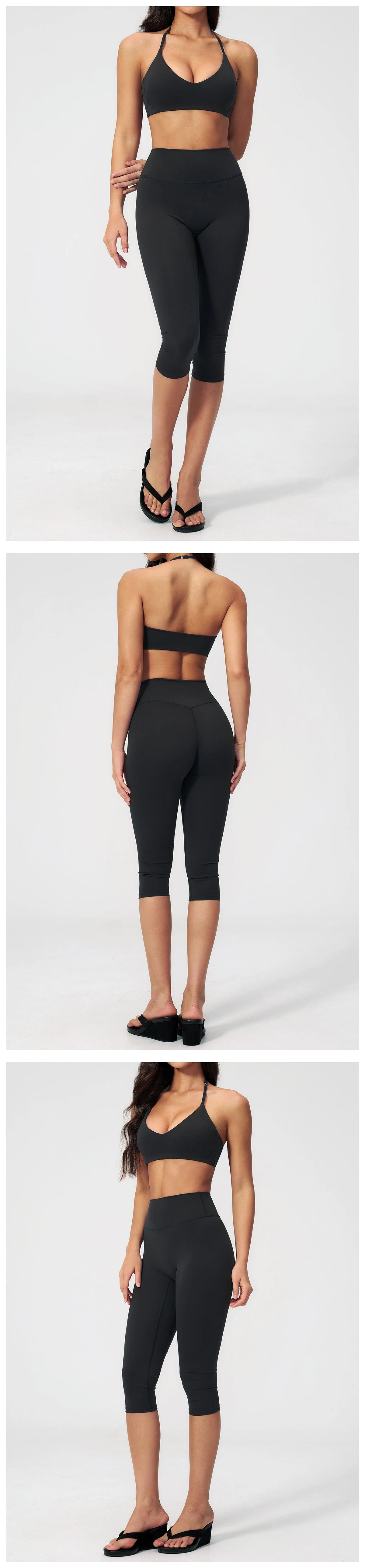 A woman models a black women's premium fitness tracksuit top and leggings.