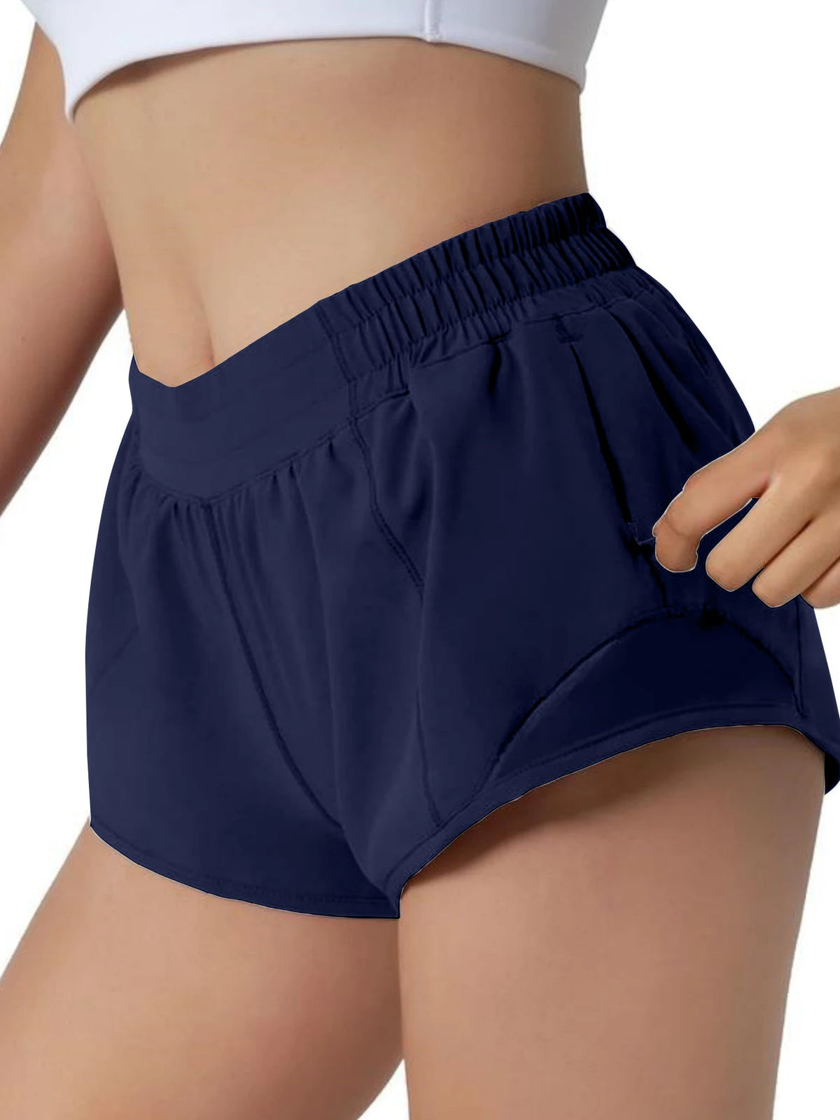 Navy women's high-waisted running shorts worn by a model.