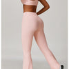 A woman models a pink 3-piece yoga sports set consisting of a crop top, leggings, and matching pants.