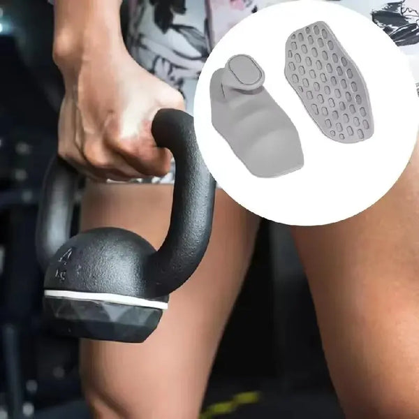 Close-up of a hand gripping a black silicone gym grip glove with a textured silicone pad.