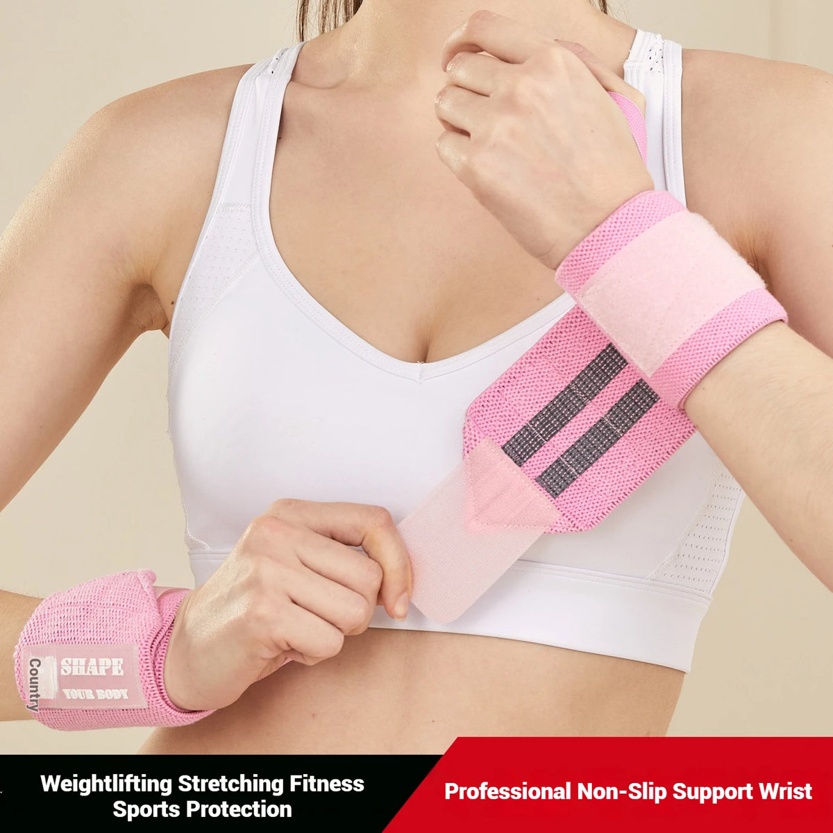 A woman is wearing a pink wrist support bandage on her arm while wearing a white sports bra top.
