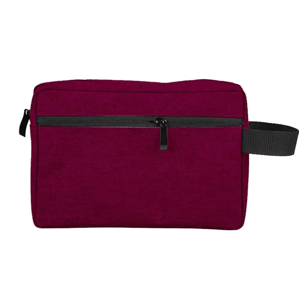 A deep magenta waterproof cosmetic and travel pouch with a black zipper and strap.