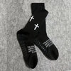 Black athletic socks with white crosses printed on the foot