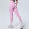 A model is wearing high-waisted pink quick-drying yoga and fitness leggings.