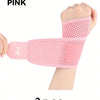 Pink adjustable wrist support brace for fitness shown on a hand.