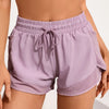 Light purple athletic shorts with drawstring waist and mesh pockets worn by a model.