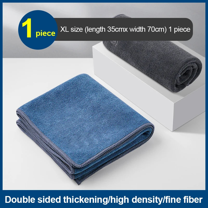 A stack of dark blue microfiber cleaning towels is shown next to a white box.