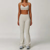 A woman models a beige 3-piece yoga sports set consisting of a cropped top, leggings, and a matching sports bra.