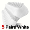 Five pairs of white performance compression ankle socks stacked and displayed.