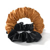 A headband made of satin fabric in shades of gold and black, used for heatless curling.