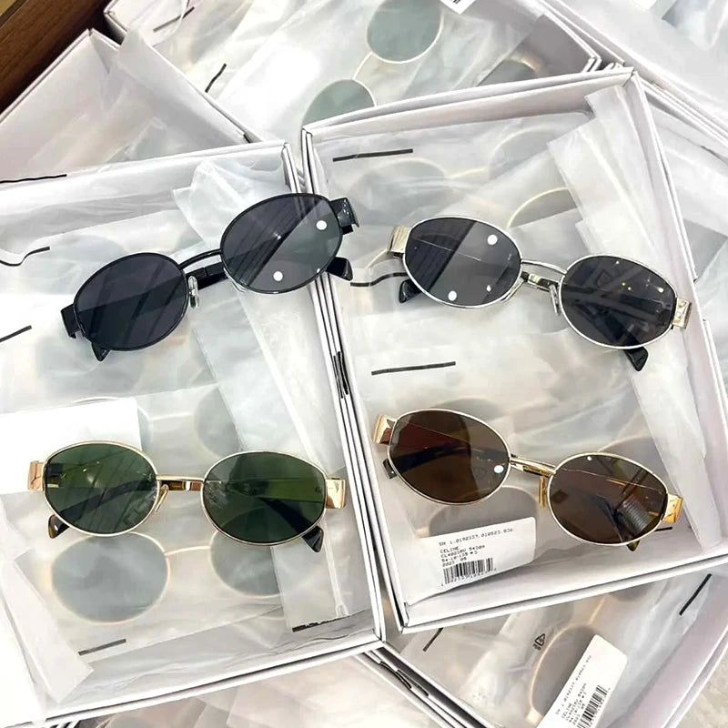 A display of classic oval metal sunglasses in various shades including black, brown, and green.