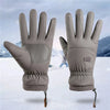 A pair of gray extreme cold-proof ski gloves displayed against a snowy background.