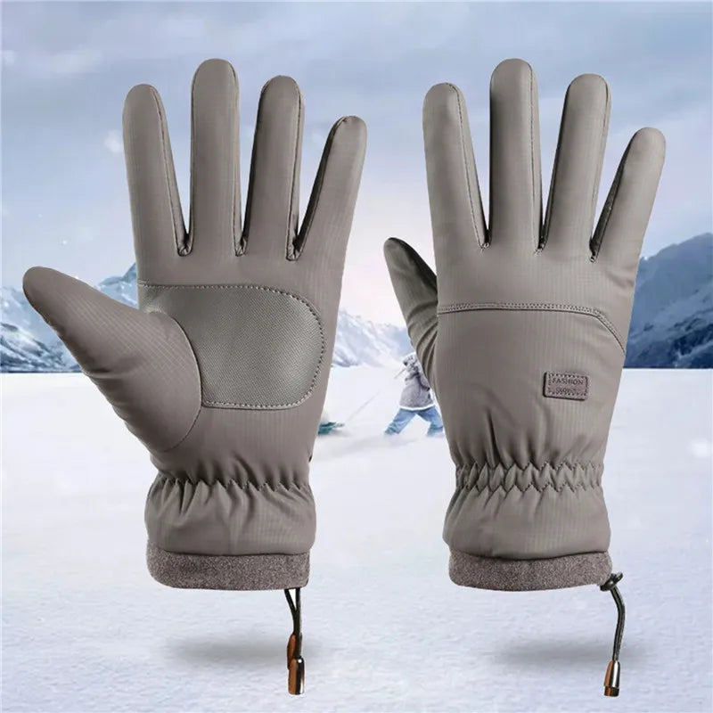 A pair of gray extreme cold-proof ski gloves displayed against a snowy background.