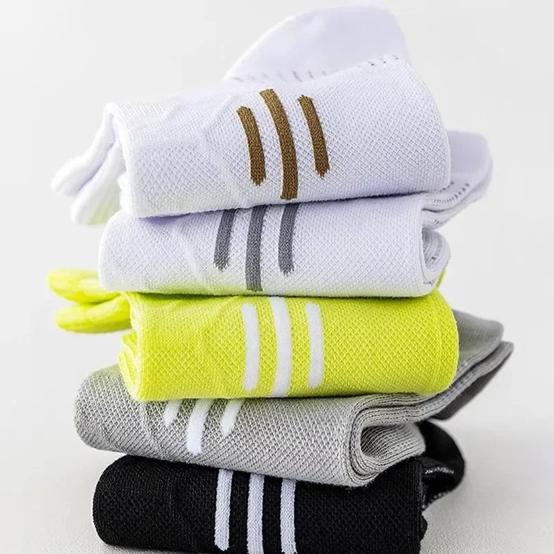 A stack of premium breathable men's running socks in white, gray, lime green, and black.
