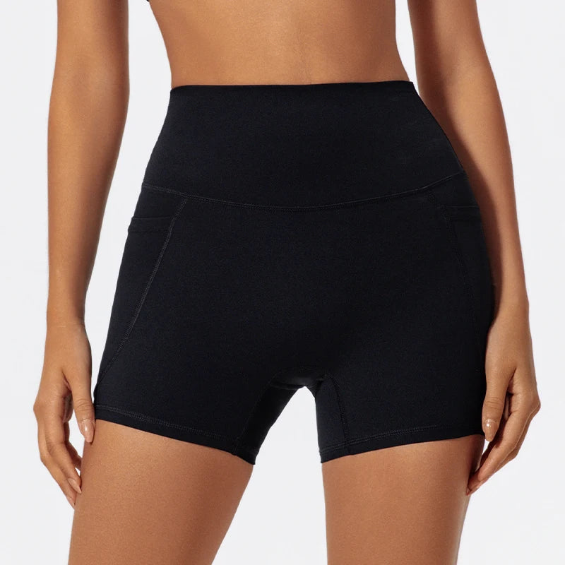 A model wearing black high-waist yoga and workout shorts.
