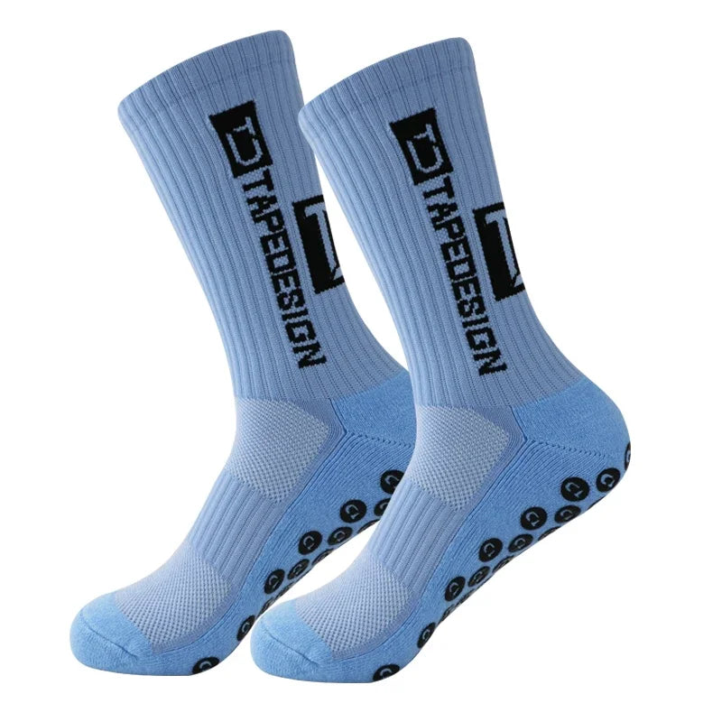 A pair of light blue anti-slip performance sports socks with black text and grip dots.
