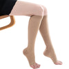 A pair of beige medical grade knee high compression stockings worn on a leg.