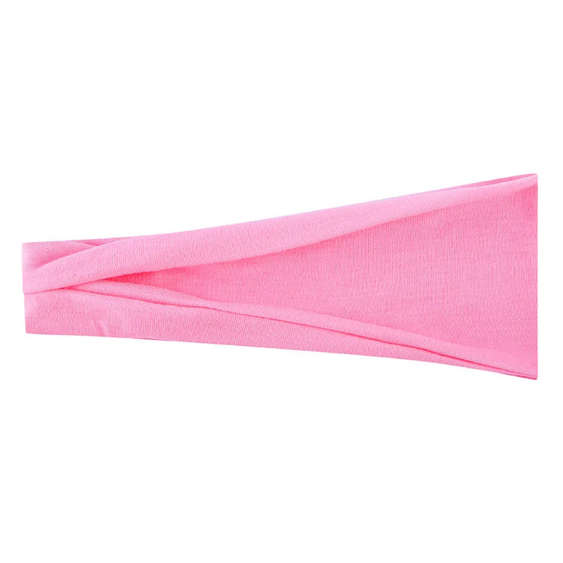 Un bandeau élastique rose plié et présenté sur un fond blanc.