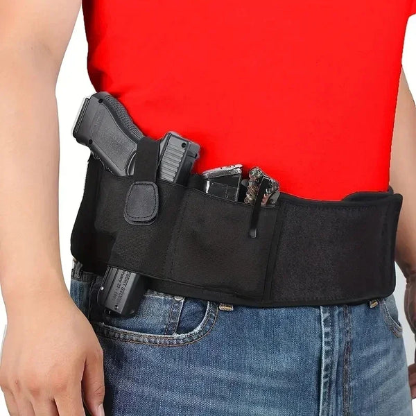 A black tactical outdoor belt with a holster and magazine is worn on a person's waist over a red shirt and blue jeans.