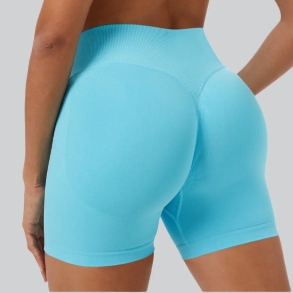 A close-up shot of a woman wearing light blue seamless high-waist yoga leggings.