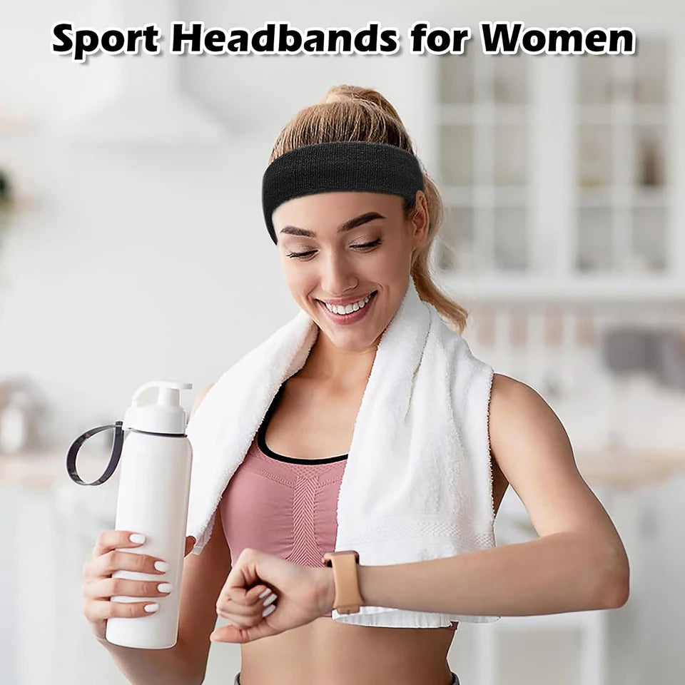 A woman wearing a black sport headband and white towel, holding a water bottle.