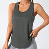 A woman wearing a dark gray athletic vest and light gray pants, posing for a product photo.