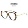 A pair of vintage oversized designer sunglasses with brown leopard print frames and gold-toned metal arms.