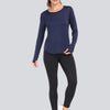 A woman models a navy blue loose fit sun protection t-shirt and black leggings.