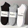 Three pairs of comfort fit ankle socks in black, gray, and white are displayed on a light surface.
