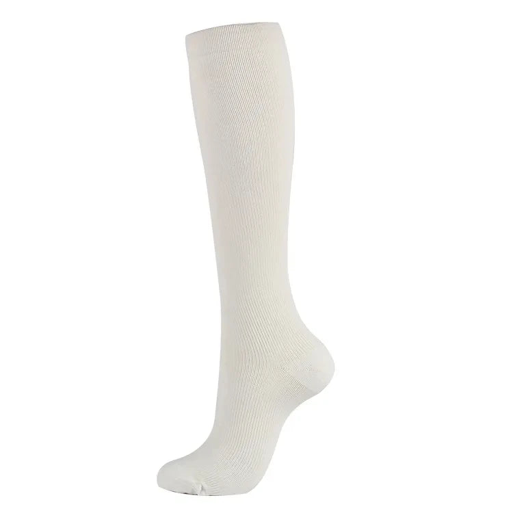 A white compression sock shown standing upright.