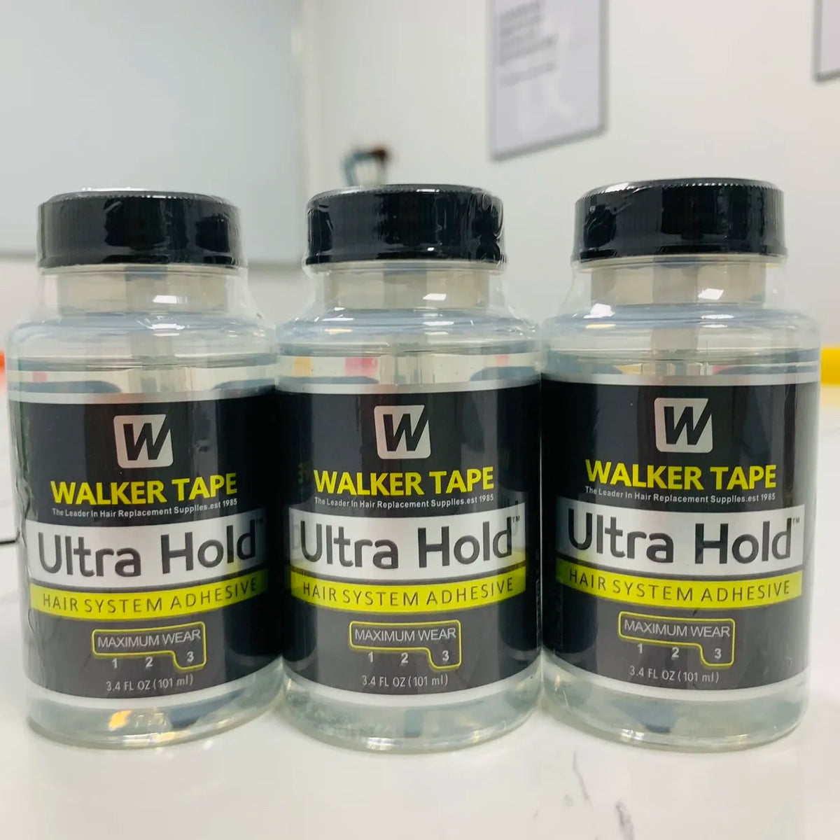 Three bottles of Walker Tape Ultra Hold hair system adhesive for lace wigs