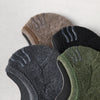 A close-up of several pairs of men's cotton crew socks in various earthy and dark tones.