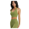 A woman models a olive green halter neck yoga and gym sports bra top.