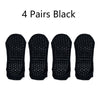 Four pairs of black non-slip yoga socks displayed side by side.