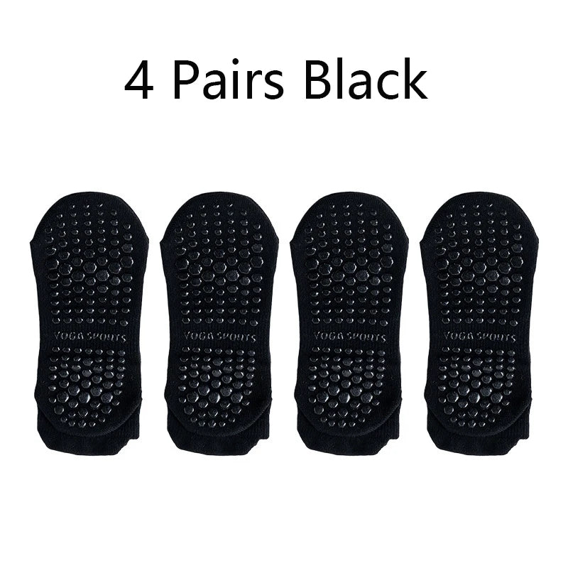 Four pairs of black non-slip yoga socks displayed side by side.